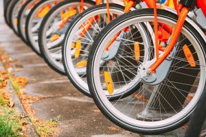 Row Of Colorful Bicycles For Rent At Municipal Bike Parking In Street