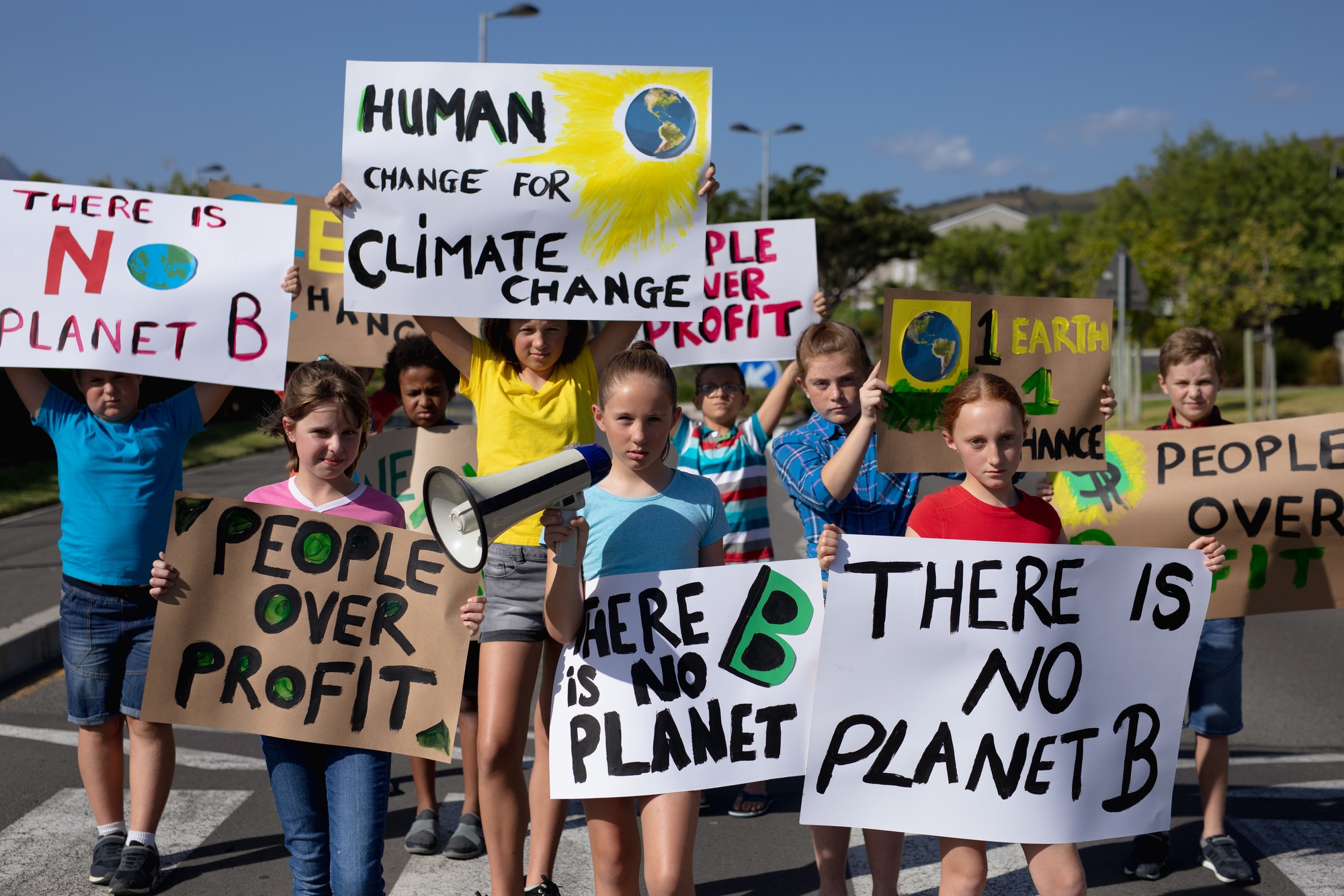 group of elementary school pupils walking on a protest march