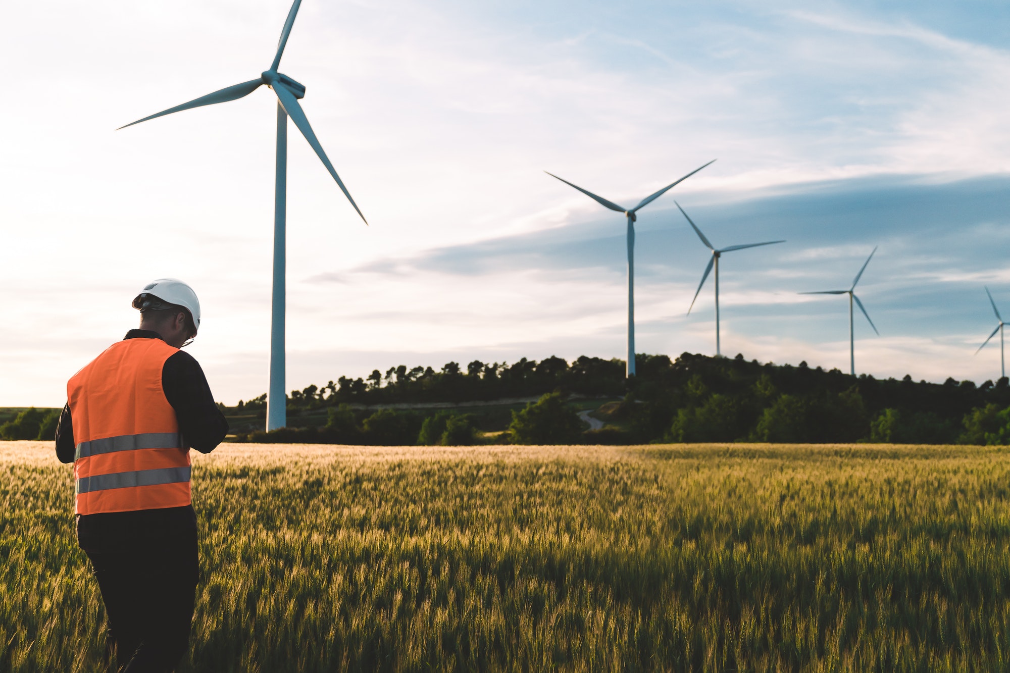 engineer working at alternative renewable wind energy farm sustainable energy industry concept